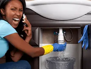 Emergency plumbing repair for a leaking sink drain under a bathroom vanity in Flagstaff, AZ