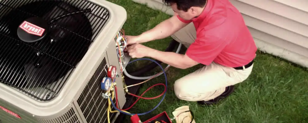HVAC technician servicing an outdoor air conditioner unit in Flagstaff, AZ