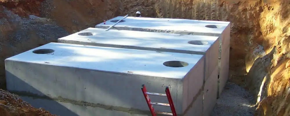 Septic tank installation site with a newly placed concrete tank in Flagstaff, AZ